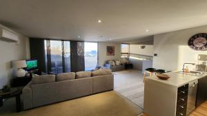 a large living room with a couch and a table at Number 9 on Cataract in Launceston