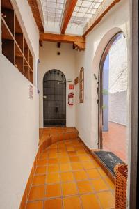 an empty hallway with an orange tiled floor in a building at Casa Aimée in Mexico City