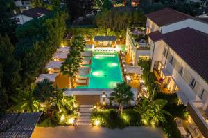 an aerial view of a swimming pool at night at Resort Miramonti in Forte dei Marmi