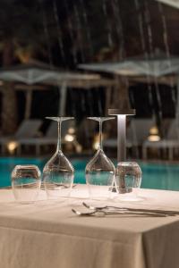 four wine glasses sitting on top of a table at Resort Miramonti in Forte dei Marmi