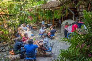 a group of people sitting at tables in a garden at Petit Mesón (Pet Friendly Hotel) in Valle de Bravo +57 photos