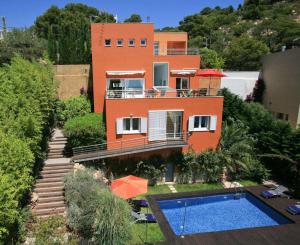a house with a swimming pool in front of it at Mar Bona in Tamariu