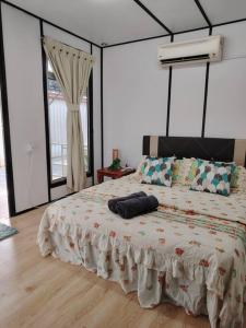 a bedroom with a large bed in a room at The Garden Homestay Kemaman in Kemaman