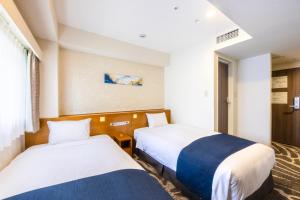 a hotel room with two beds and a window at Shinjuku Washington Hotel in Tokyo +65 photos