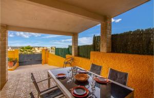 a table and chairs on the patio of a house at Amazing Home In Gran Alacant in Santa Pola +31 photos