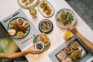 a table with plates of food on it at Holiday Inn Resort Bali Canggu by IHG in Canggu