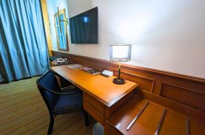 a room with a desk with a lamp on it at Park Avenue Hotel Sungai Petani in Sungai Petani