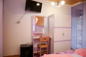 a bedroom with a desk and a chair and a mirror at Станчевата Къща in Zlatograd