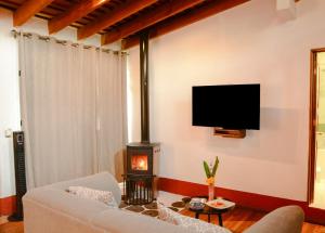 a living room with a couch and a fire place at Mesón De Leyendas Breakfast & Downtown in Valle de Bravo