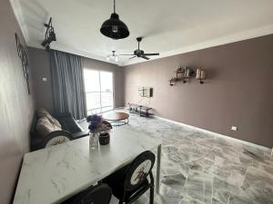 un salon avec une table et un canapé dans l'établissement B 13a-7 De MARINA VIEW VILLAS, à Port Dickson