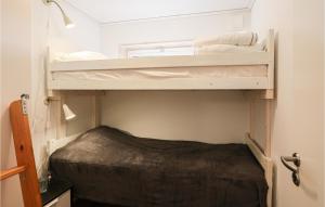 a small room with two bunk beds in it at 3 Bedroom Gorgeous Home In Löttorp in Löttorp +7 photos