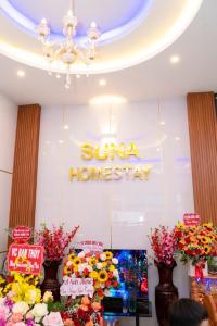 a store with flowers and a sign on the wall at Homestay SUNA in Tuy Hoa