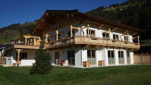 a large house with a balcony on top of it at Appartement Sonnenschein in Ramsau im Zillertal
