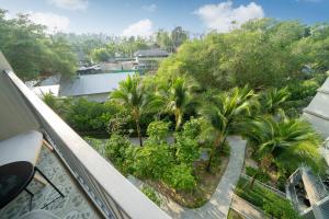 a balcony with palm trees and a view of a city at The Title Residencies Nai Yang - 1 Bedroom Apartment in Nai Yang Beach