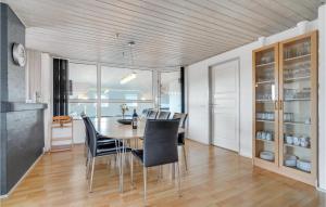 a dining room with a table and chairs at Cozy Home In Hvide Sande With Sauna in Bjerregård