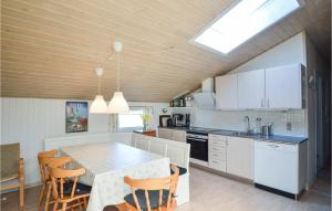 a kitchen with a table and chairs in a room at Holiday Home Ringvejen Rømø Iv in Rømø +10 photos