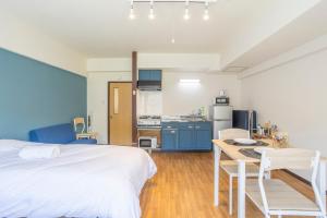 a bedroom with a bed and a desk and a kitchen at Lake Toya BLDG 2F-3F in Lake Toya
