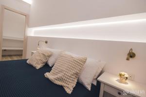a bedroom with a bed with two pillows on it at Giuliana in Letojanni +24 photos