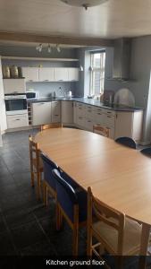 a kitchen with a wooden table and chairs at Byens Bed and Bath in Nakskov