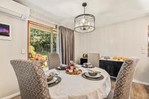 a dining room with a table and chairs at Birdsong Alley Bed and Breakfast in Hanmer Springs