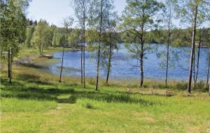 a view of a lake with a boat in the water at One-Bedroom Holiday Home In Ed in Fagerhult +3 photos