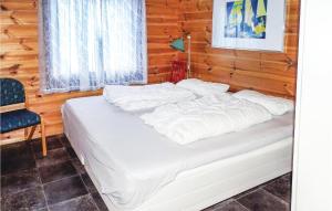 a bedroom with a white bed with a blue chair at Nice Home In Dirdal With House Sea View in Dirdal