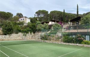 a tennis court in front of a house at Beautiful Apartment In Nisportino in Nisporto