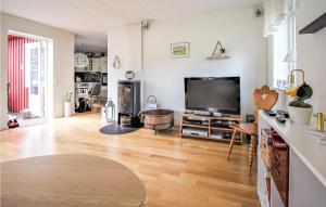 a living room with a large flat screen tv at Awesome Home In Hörby With Kitchen in Hörby