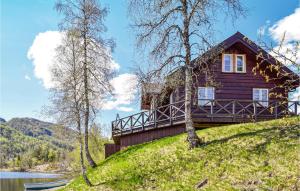 a house on a hill next to a lake at Tokagjelet in Norheimsund +24 photos