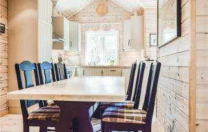 a dining room and kitchen with a table and chairs at Tokagjelet in Norheimsund