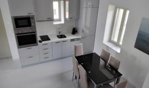 a kitchen with a table and chairs and a sink at Skoutari Bay View Mani Peninsula in Skoutari