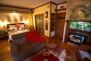 a living room with a couch and a fireplace at Shiloh Station House in Franklinford