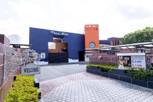 a building with a welcome sign in front of it at HOTEL Villamure Ogori -ADULT ONLY- in Tosu