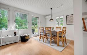 a kitchen and dining room with a table and chairs at Two-Bedroom Holiday Home In Ebeltoft in Ebeltoft