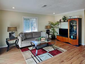 a living room with a couch and a tv at Sea Urchin 39 in Saint Augustine