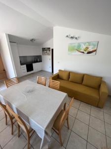 a living room with a table and a couch at Apartments Klabjan in Osp