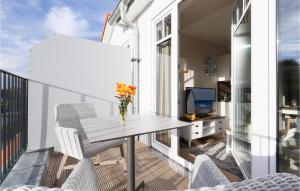 a balcony with a table and chairs and a tv at Baltischer Hof Apartment 50 in Boltenhagen