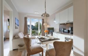 a kitchen and living room with a table and chairs at Baltischer Hof Apartment 50 in Boltenhagen