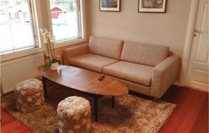 a living room with a couch and a coffee table at Amazing Home In Strömstad With Sauna in Lökholmen