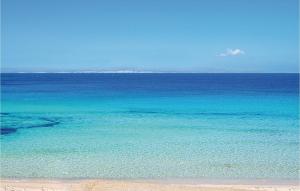 a large body of blue water with a beach at Casa Pirato in Modica