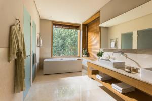 デヘラードゥーンにあるSix Senses Vana - A Wellness Retreatの洗面台2つと浴槽1つ、窓のあるバスルーム +37枚の写真