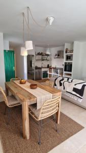 a room with a wooden table and chairs and a bed at La Islita in Playa Blanca +6 photos