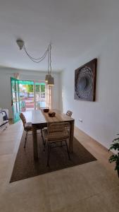 a dining room table and chairs in a living room at La Islita in Playa Blanca