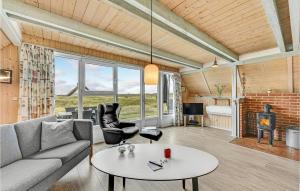 a living room with a couch and a table at Holiday Home Hvide Sande With A Fireplace 05 in Bjerregård