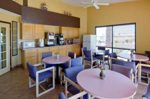 a restaurant with tables and chairs and a kitchen at Americas Best Value Inn - Phoenix, AZ in Phoenix