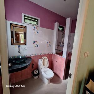 a pink bathroom with a toilet and a sink at ณดา เกาะล้าน รีสอร์ท in Ko Larn +46 photos