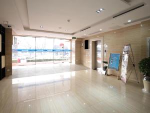 a lobby with a sign on the floor of a building at Citytel Inn in Beijing