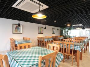 a dining room with tables and chairs at Citytel Inn in Beijing