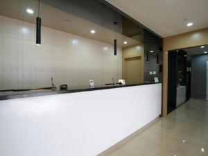 a large kitchen with a large white counter in a room at Citytel Inn in Beijing +171 photos