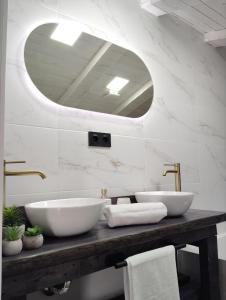 a bathroom with two sinks and a large mirror at La BUHARDILLA DE CHARLIN in Casas de Ves +46 photos